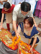 Mother Shailja, father Arun Kumar and younger sister with the body of Capt Megha Razdan in Pathankot on Monday. Photo: N.P. Dhawan