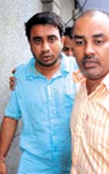 A Gujarati businessman Raj Bhai Himat Ram Malvi (L) after being rescued by the Delhi Police from kidnappers in the Capital