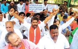 Shiv Sena activists stage a dharna to protest against conversion charges and parking fare in the Capital