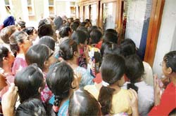 Anxious girls gather in front of the notice board put up at Govt College for Women, Ludhiana