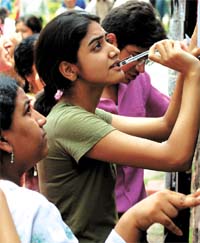 Final-list tension: Admission seekers at Delhi University see the final cut-off list in the Capital on Thursday.