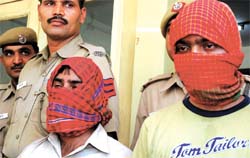 Suresh and Sunil, arrested for threatening a businessman and demanding Rs 5 lakh, being paraded in front of the media in the Capital on Thursday.