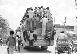 The picture above should gladden the hearts of educationists in Haryana to see how, leave aside school or college students, even small children are hanging on precariously to the rear of the bus to reach schools. Safety ? Well, that might take a back seat in the circumstances.