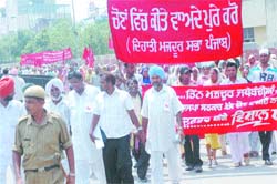 Members of mazdoor associations take out a protest march in Jalandhar