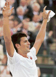 Novak Djokovic rejoices after defeating Marcos Baghdatis in the quarterfinal at Wimbledon on Friday.