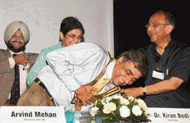 Arvind Mehan, Rotary club president, seeks the blessings of Rajendra K. Saboo, former Rotary International chief, as Dr Kiran Bedi looks on in Chandigarh on Monday evening.