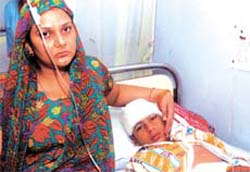 An injured schoolchild with his mother at hospital after the RTV mishap in the Capital on Monday.