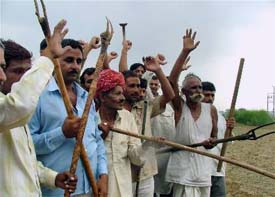 Lathi-wielding villagers protest against the setting up of a special economic zone (SEZ) near Gurgaon on Monday.
