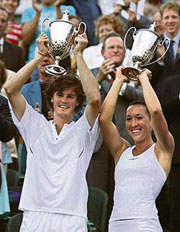 Britains Jamie Murray (left) and Serbias Jelena Jankovic hold their trophies after winning the mixed doubles final against Swedens Jonas Bjorkman and Australias Alicia Molik at Wimbledon on Sunday