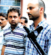 Suspects in a fake currency racket, Kuldeep Grover (R) and Vivek Chaudhary in police custody.