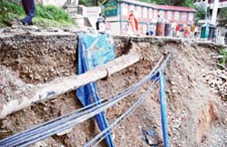 A view of cables dangling precariously along a prime road just in front of the high court in Shimla