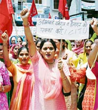 Activists of the Anganwari Workers Union hold a protest march in Hamirpur 
