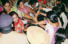 Aanganwari workers being forcibly stopped by the Railway Protection Force at the railway station in Ludhiana on Tuesday.