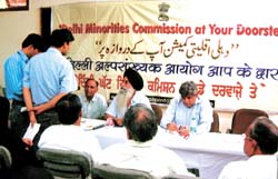 Arnold James, Pushpender Singh, members, K. S. Wahi, secretary, Delhi Minorities Commission, listen to the grievances of public during a function 'Doorsteps' at Gole Market in the Capital 