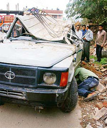 A vehicle that was damaged in a landslide at Kachi-Ghati, near Shimla, on Wednesday morning.