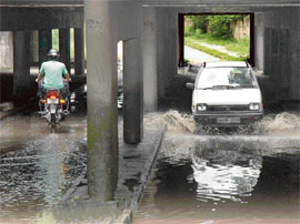 A car moves through the waterlogged subway dividing Sectors 11 and 15 in Chandigarh on Thursday.