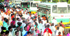 Commuters at an ITO bus stop wait for their turn to get into a bus in the Capital on Thursday.