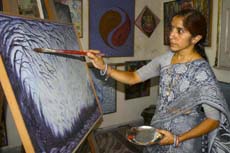 Mala Chawla gives final touches to her painting.