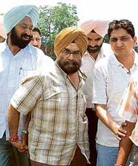 B.I.S. Chahal, former media adviser to Capt Amarinder Singh, being produced in court in Patiala on Friday.