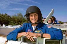 Mission Specialist Williams helmeted and ready to practise driving a M-113 armoured personnel carrier.