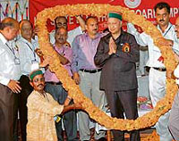 Office-bearers of the Himachal Pradesh Electricity Board Union garland Chief Minister Virbhadra Singh during a meeting of the union in Palampur on Saturday.