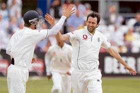 Graham Onions (right) of England Lions celebrates with team-mate Joe Denly after dismissing VVS Laxman on the second day of the three-day warm-up match at Chelmsford