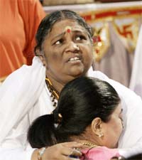 Mata Amritanandamyahi Amma gives a hug or darshan to a follower during the last day of her three-day visit to New York