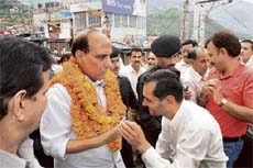 A BJP worker welcomes party chief Rajnath Singh at Dharamsala on Sunday.