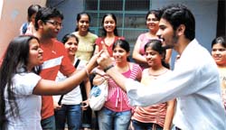Despite tight security, seniors show their true colours to juniors on their first day at Kirori Mal College in Delhi University on Monday.