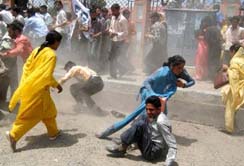 Agitating members of the Jammu and Kashmir Unemployed Teachers Forum run for safety following the use of police force during a demonstration in Srinagar