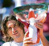 Spains David Ferrer raises the trophy after defeating compatriot Nicolas Almagro 6-1, 6-2 in the final of the Swedish Open tennis tournament in Bastad on Sunday.