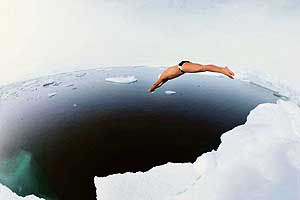 This photo provided by Push Pictures shows British explorer and endurance swimmer Lewis Gordon Pugh diving into the waters of the Geographic North Pole, on Sunday.