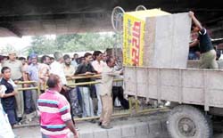 Municipal Committee workers busy removing a rehri from a dhaba during a demolition drive in Ambala