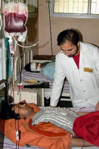An injured piligrim being treated by doctor at SKIMS Hospital in Srinagar on Wednesday.