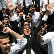 Pakistani lawyers shout anti-Musharraf slogans in Lahore on Wednesday as they take part in a protest against a suicide bomb attack at a rally in Islamabad.