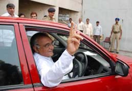 Haryana Chief Minister Bhupinder Singh Hooda waves as he drives his own Honda City to the Vidhan Sabha to cast his vote in the presidential poll in Chandigarh on Thursday.