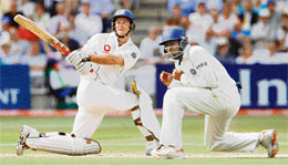 Englands Andrew Strauss plays a shot past Indias Wasim Jaffer on the first day of the first Test at Lords in London on Thursday. 
