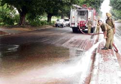 Fire tenders clean the slush from the road separating Sectors 10 and 11 in Chandigarh on Friday.