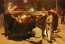 Police officials inspect a Scorpio that toppled after colliding with an Alto car near the Chandigarh Club on Thursday night.