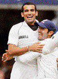 Zaheer Khan (left) celebrates with Dinesh Karthik after dismissing Englands Kevin Pietersen on the second day of the first Test at Lords in London on Friday.