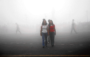 Students enjoy the misty weather on The Ridge in Shimla on Saturday.