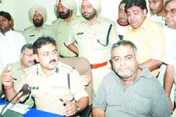 SSP Arpit Shukla and rescued trader Ashok Madaan (right) at a press conference at the Police Lines in Jalandhar