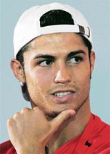 Cristiano Ronaldo of Manchester United reacts during a news conference in Macau