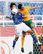 Japan's Naohiro Takahara (L) and Australia's Mark Milligan battle for the ball during their quarterfinals match at the 2007 Asian Cup soccer tournament in Hanoi