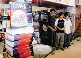 Eager fans wait for the clock to strike the magical hour at a city bookstore