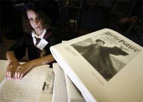Kristin Turgeon (11) reads her Braille copy of the final book in the Harry Potter series, Harry Potter and the Deathly Hallows, at the National Braille Press in Boston