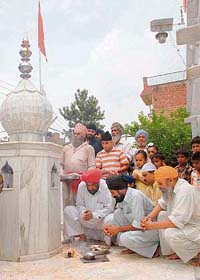 Residents of Dadu Majra perform a puja for rain at their village