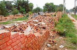 Unscrupulous elements have broken the boundary wall of Kumar Colony in Sector 25, Chandigarh, to sell the bricks