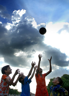 Children playing under the cloudy skies at Rajpath in the Capital 