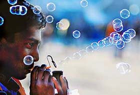 In a bid to attract customers, this vendor blows out bubbles in the air on The Mall in Shimla